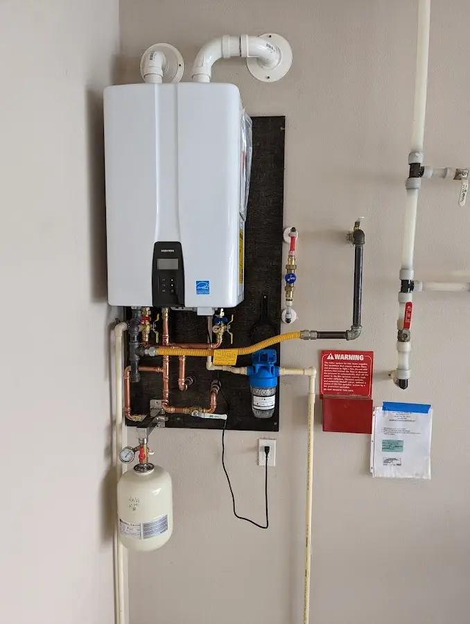 Professional plumber installing copper piping in a Englewood home